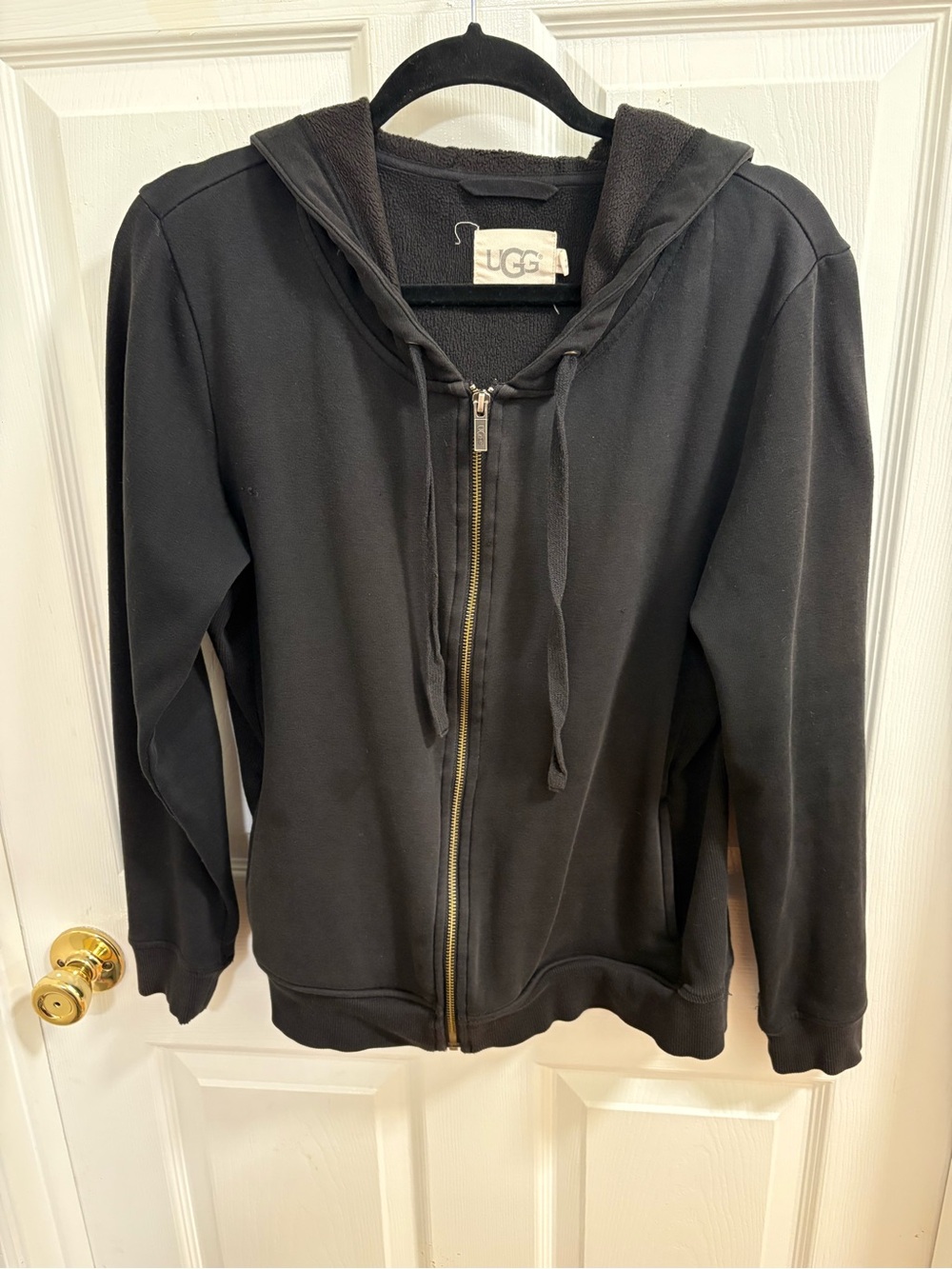 a black UGG full-zip hooded sweatshirt. Front zip